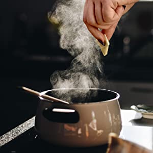Dipping Blate Papes broth bomb into steaming pot